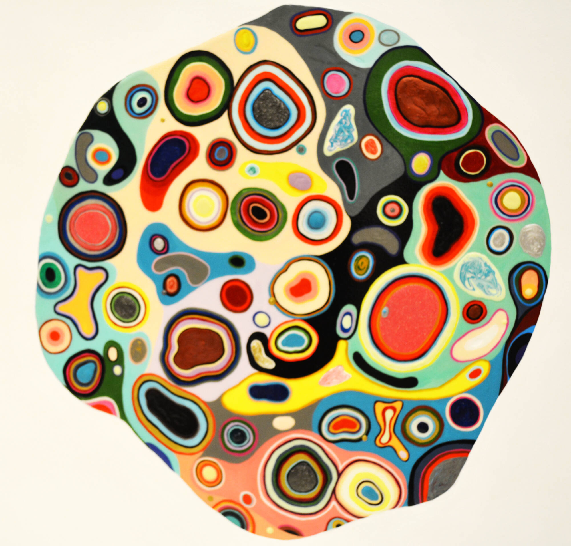 Abstract shape full of "blobs" of stacked colors that look like a cell.